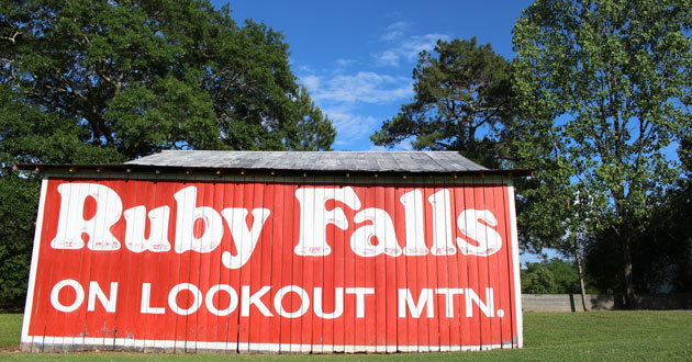 A ruby falls sign on the side of a barn