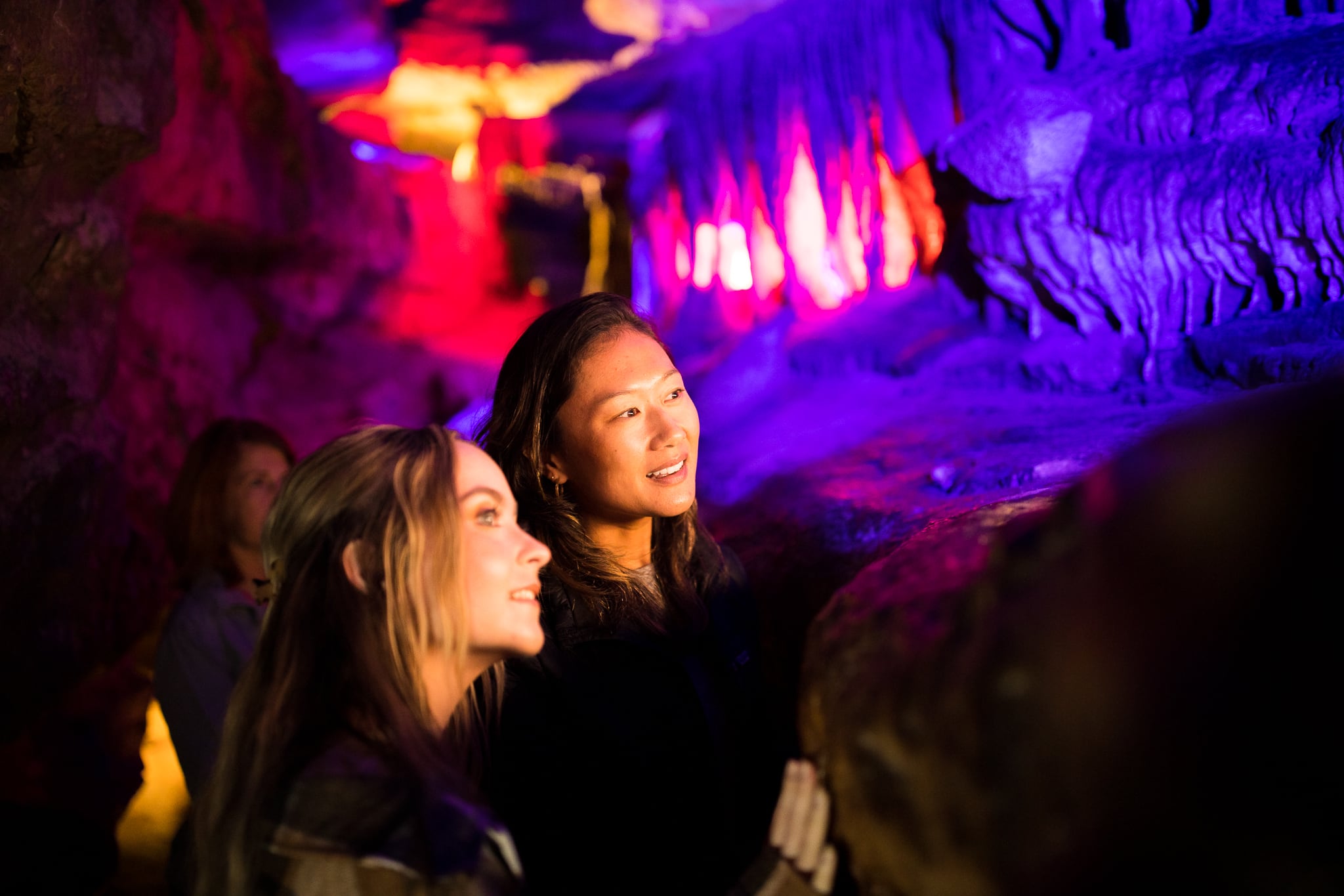 Two women look at cave formations