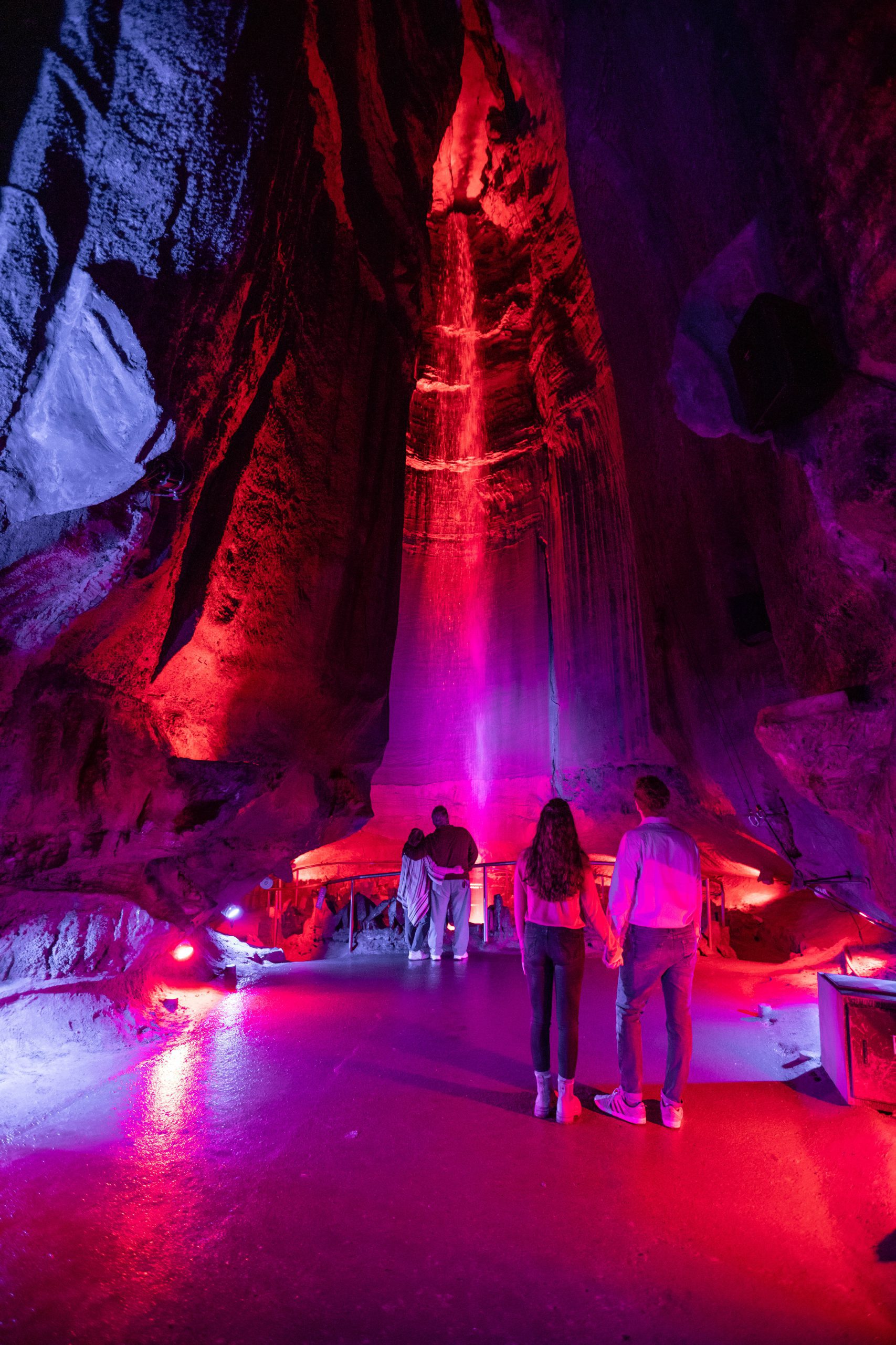 A couple hold hands in front of Ruby Falls