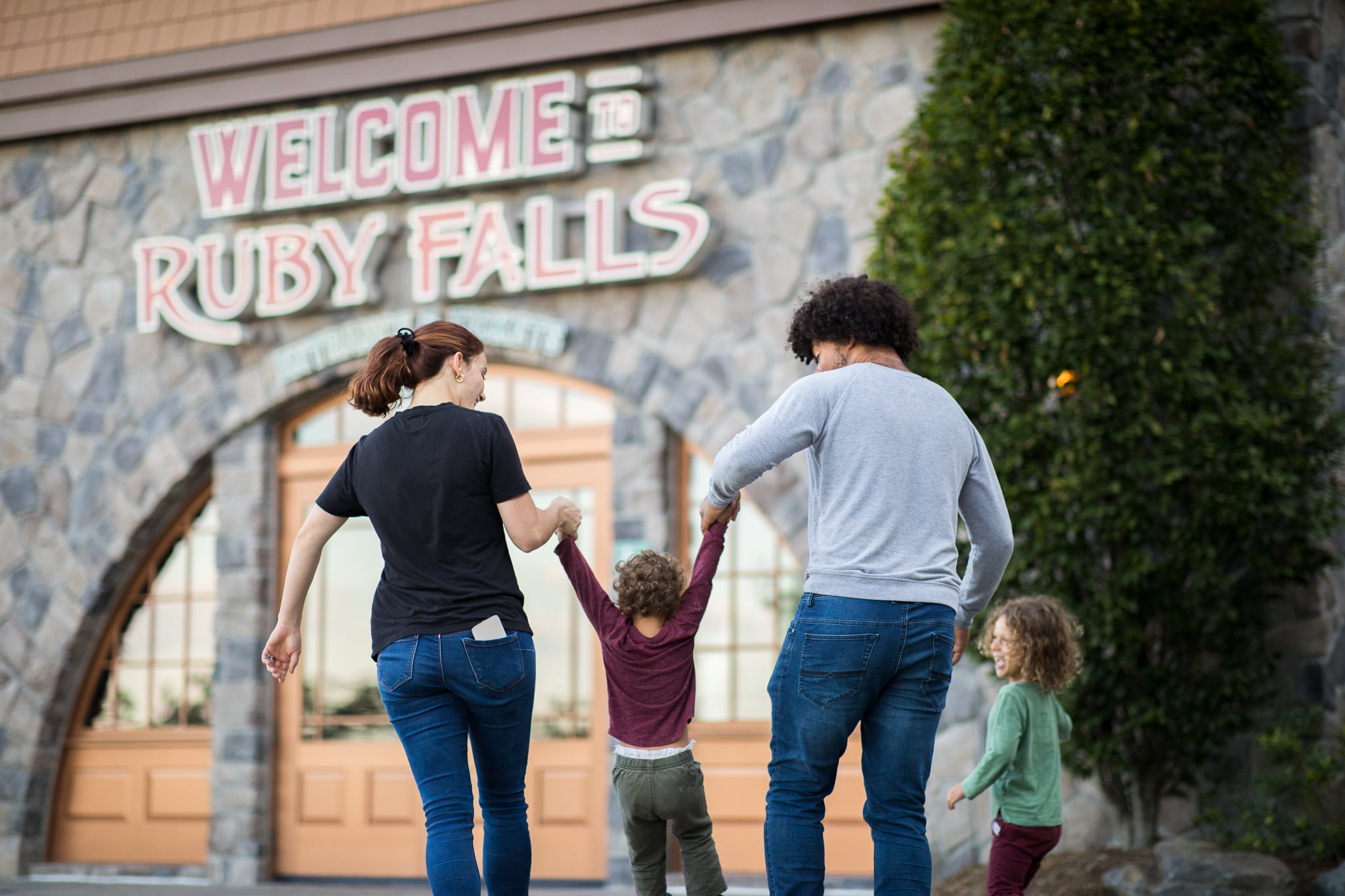 A man, woman and two kids enter the Ruby Falls welcome center