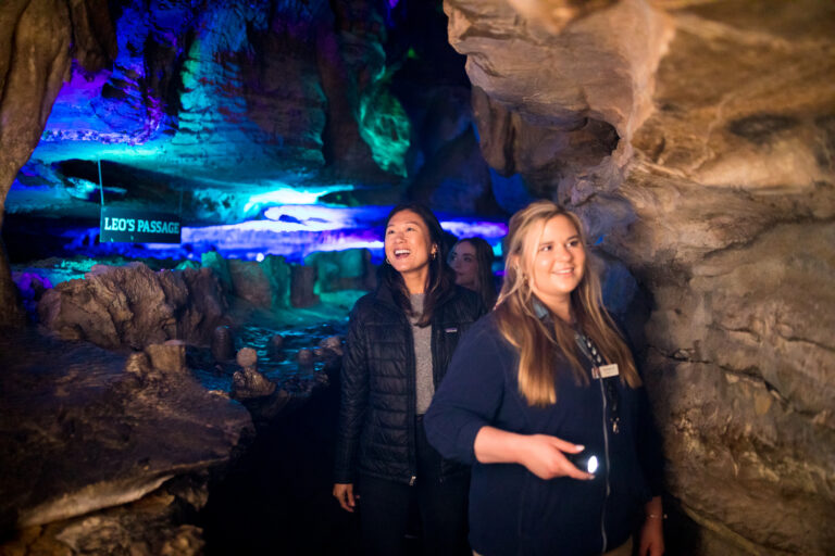 Tour guide leading a tour with a flashlight in the caves of Ruby Falls