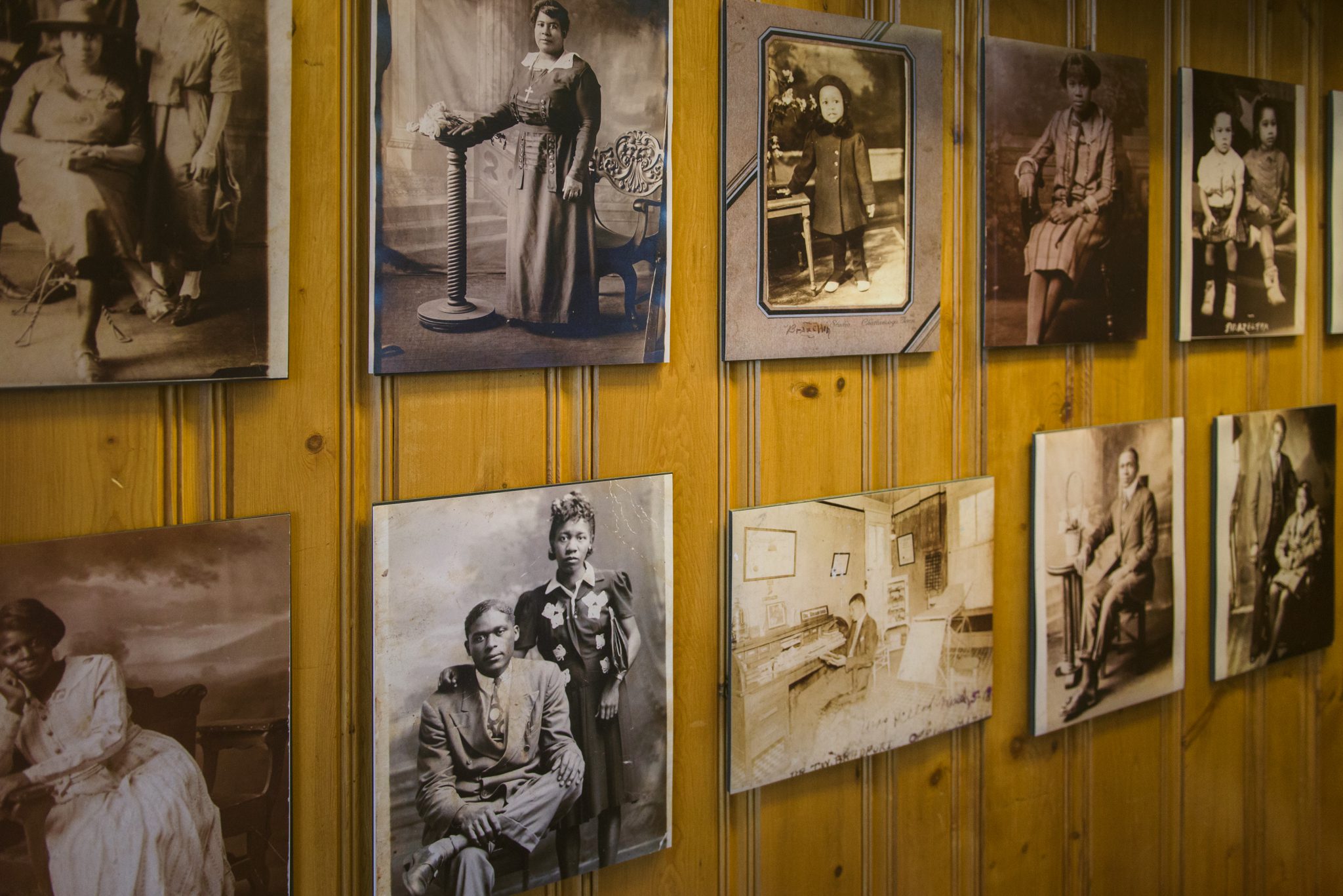 A collection of black and white images hanging on a wall