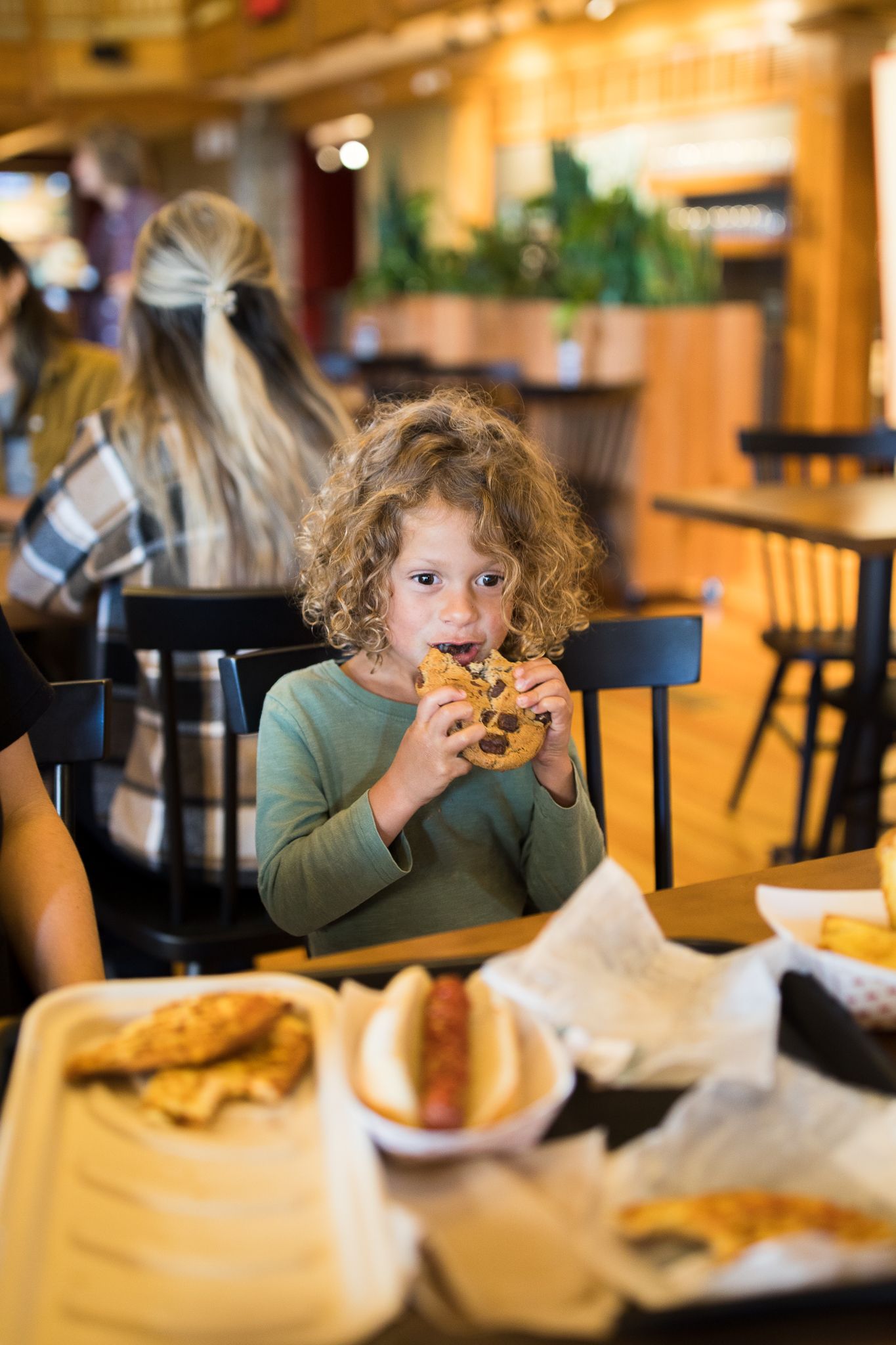 Child eating a cookie in the food court