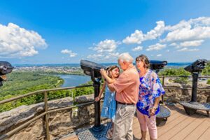 Two grandparents with a grand daughter over looking Chattanooga from the Ruby Falls tower