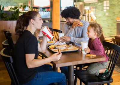 A family of four eats a meal in the Ruby Falls food court 