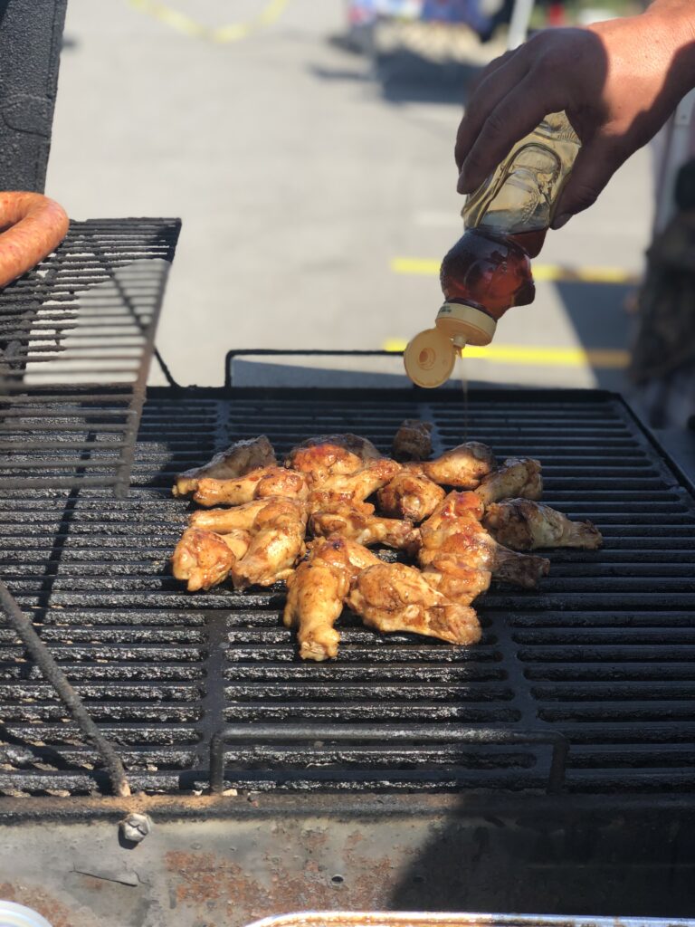 Someone out of view cooking up meat on a grill