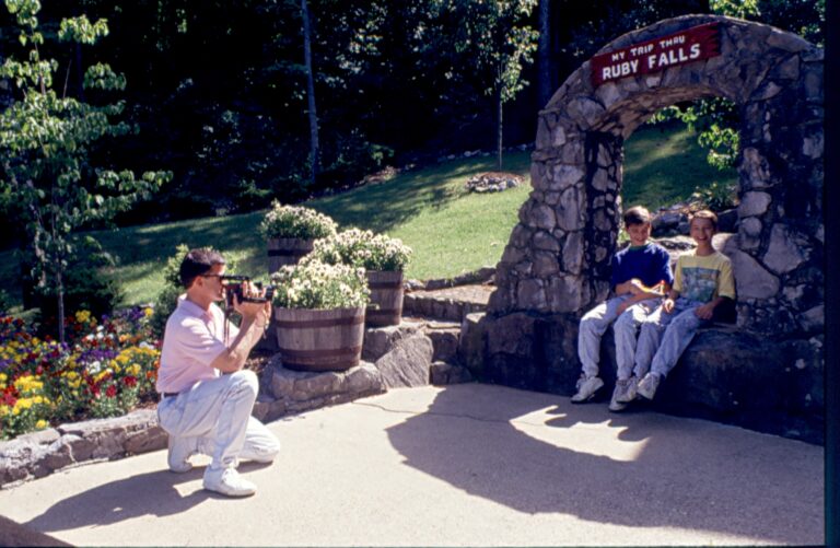 Vintage color photo in the 1980s of a woman taking a photo of people at Ruby Falls