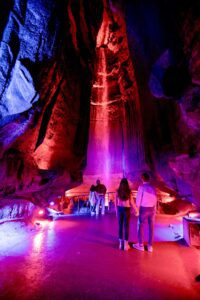 People at Ruby Falls with red lighting