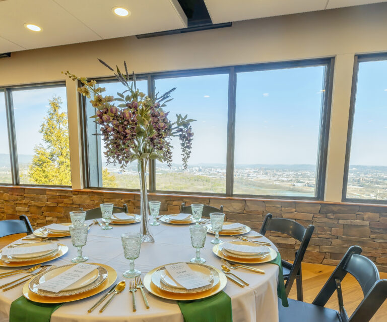 Round table with white tablecloth and floral arrangement