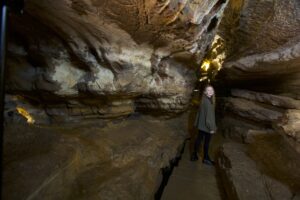 Young adult woman standing on the cavern trail in Ruby Falls Cave