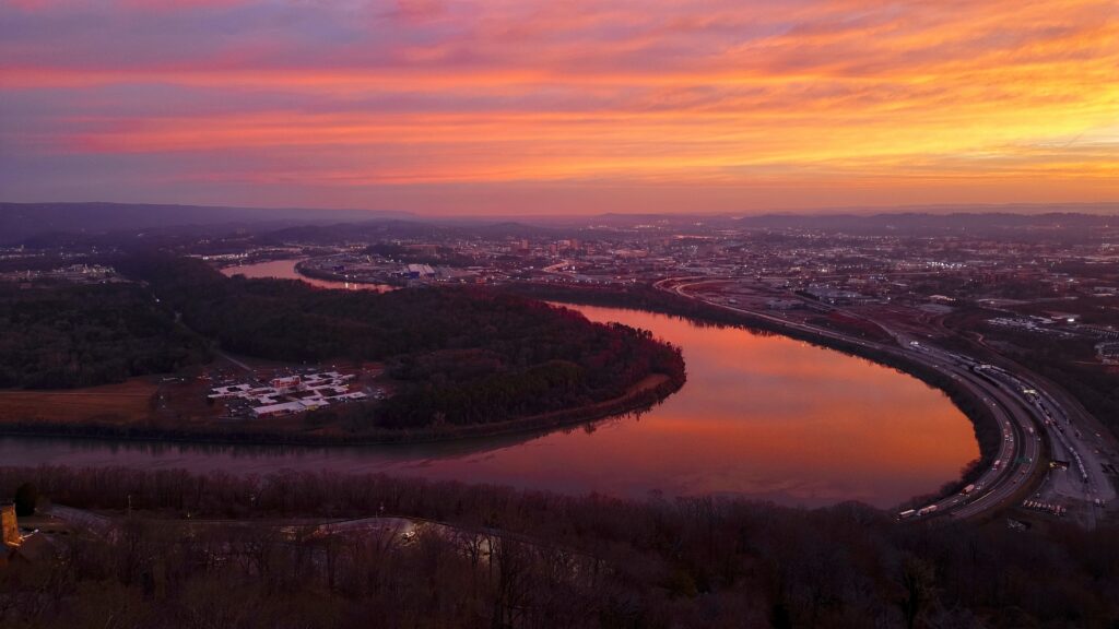 Sunrise featuring a pink and orange sky reflecting on the Tennessee River.