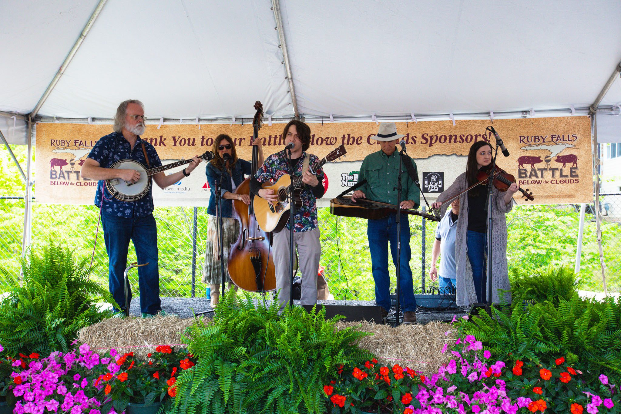 A 5-piece Bluegrass band performs on a stage at Battle Below the Clouds